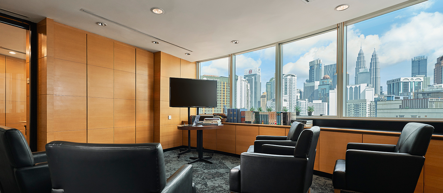 An empty conference room with monitor and sofas to sit.