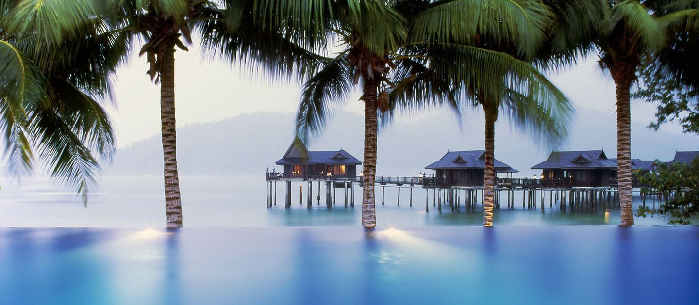 A scenic view of a chalet and ocean.