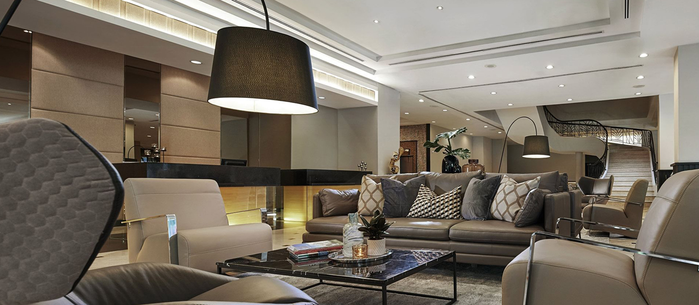 Hotel lobby with couches and tables for visitors to sit.